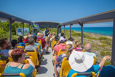 Passengers riding covered open-top bus