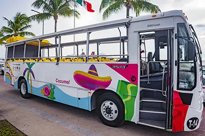 Colorful open-top bus parked Cozumel